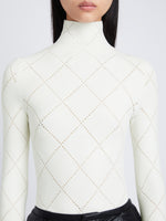 Detail image of model wearing Pointelle Diamonds Turtleneck Top in OFF WHITE
