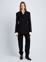 Front full length image of model wearing Wool Stretch Suiting Jacket in BLACK with jacket buttoned
