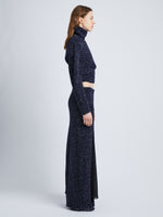 Side full length image of model wearing Technical Sequin Sweater in NAVY