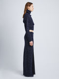 Side full length image of model wearing Technical Sequin Knit Skirt in NAVY