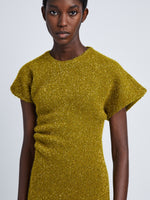 Detail image of model wearing Technical Sequin Knit Dress in CHARTREUSE