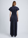 Back full length image of model wearing Technical Sequin Knit Dress in NAVY