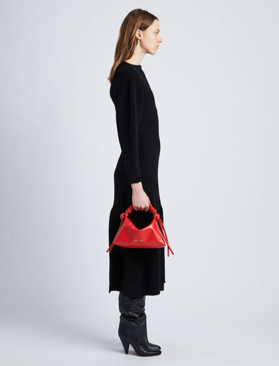 Image of model wearing Mini Drawstring Bag in NEW SCARLET