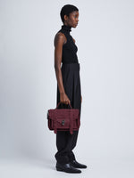 Image of model wearing Suede PS1 Medium Bag in BORDEAUX