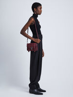 Image of model wearing Suede PS1 Mini Crossbody Bag in BORDEAUX