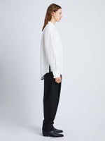 Side full length image of model wearing Crushed Matte Satin Shirt in WHITE