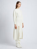 Side full length image of model wearing Wool Viscose Boucle Dress in IVORY