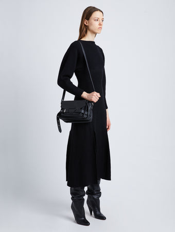 Image of model wearing Beacon Saddle Bag in BLACK