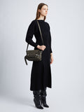 Image of model wearing Beacon Saddle Bag in OLIVE