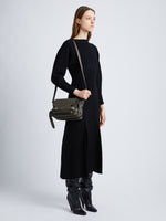 Image of model wearing Beacon Saddle Bag in OLIVE
