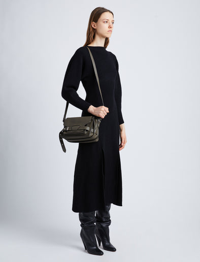 Image of model wearing Beacon Saddle Bag in OLIVE