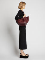 Image of model wearing Carved Python Large Ruched Tote in BORDEAUX
