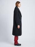 Side full length image of model wearing Melange Wool Boucle Coat in CHARCOAL
