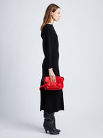 Image of model wearing Beacon Saddle Bag in ROSSO