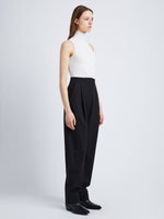 Side full length image of model wearing Wool Twill Trousers in BLACK