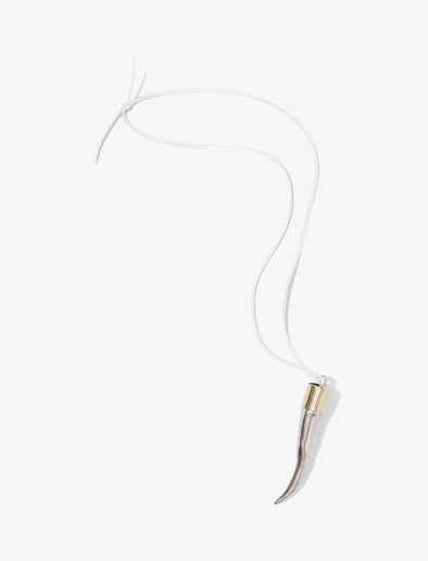 Proenza Schouler flat lay image of Horn Pendant Necklace in silver/gold