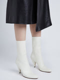 Image of model wearing CONE ANKLE BOOTS in CREAM