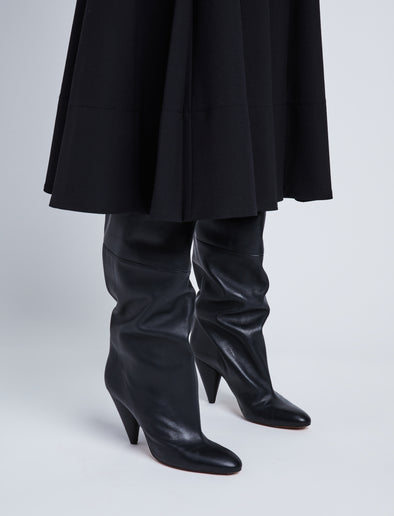 Image of model wearing CONE SLOUCH OVER THE KNEE BOOTS in BLACK