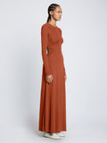 Side full length image of model wearing Long Sleeve Jersey Open Back Dress in RUST