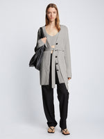 Front full length image of model wearing Ribbed Cotton Relaxed Cardigan in GREY MELANGE with belt tied in front