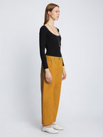 Side full length image of model wearing Solid Cotton Linen Easy Pants in GOLD