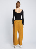 Back full length image of model wearing Solid Cotton Linen Easy Pants in GOLD
