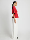 Side full length image of model wearing Eco Cotton Waisted T-Shirt in POPPY
