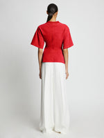 Back full length image of model wearing Eco Cotton Waisted T-Shirt in POPPY