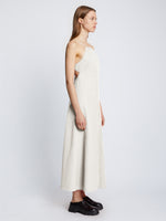 Side full length image of model wearing Drapey Suiting Cut Out Dress in OFF WHITE