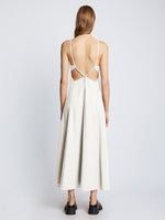 Back full length image of model wearing Drapey Suiting Cut Out Dress in OFF WHITE