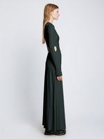 Side full length image of model wearing Long Sleeve Jersey Open Back Dress in PINE