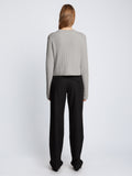 Back full length image of model wearing Ribbed Cotton Wrap Sweater in GREY MELANGE