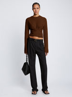 Front full length image of model wearing Ribbed Cotton Wrap Sweater in ESPRESSO with straps tied around waist
