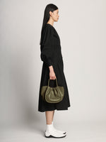 Image of model carrying Small Ruched Crossbody Tote in OLIVE on shoulder