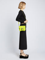 Image of model carrying Carved Python PS1 Mini Crossbody Bag in SULPHUR