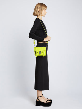 Image of model carrying Carved Python PS1 Mini Crossbody Bag in SULPHUR