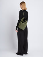 Image of model wearing Suede Spring Bucket Bag in BAMBOO 