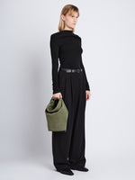 Image of model wearing Suede Spring Bucket Bag in BAMBOO