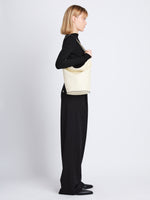 Image of model wearing Leather Spring Bucket Bag in IVORY