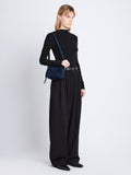 Image of model wearing Suede Watts Camera Bag in NAVY
