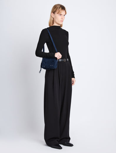 Image of model wearing Suede Watts Camera Bag in NAVY