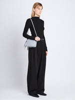 Image of model wearing Watts Camera Bag in ASH