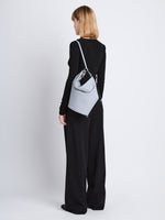 Image of model wearing Spring Bag In Leather in ash as sling