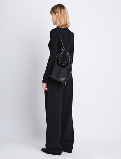 Image of model wearing  image of Spring Bag In Leather in black as sling