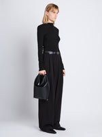 Image of model wearing  image of Spring Bag In Leather in black in hand