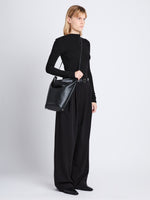 Image of model wearing  image of Spring Bag In Leather in black as crossbody