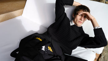 Male model laying on white couch