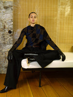 Proenza Schouler image of model sitting wearing Vanne Top In Argyle Velvet Knit in Navy Multi