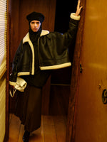 Image of model wearing Alya Jacket in Shearling in Black/white in a dimly lit room