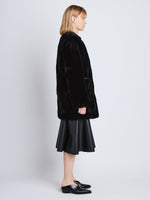 Side full length image of model wearing Penelope Coat in BLACK